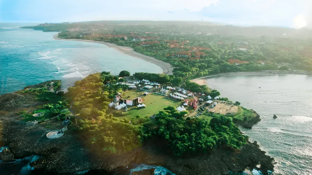 Aerial view of the Bukit Peninsula coastline in South Bali, showing cliffs, beach, and coastal development